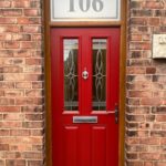 Composite door in red with golden oak frame, with bespoke number in fan light - Beeston